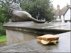Brown crisp sandwich in front of a lion statue