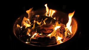 Burning Quavers roll surrounded by ash and flames