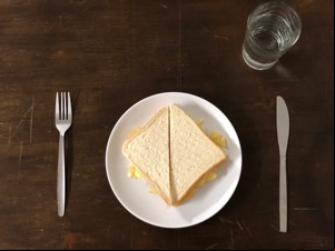Diagonally-cut crisp sandwich with knife and fork