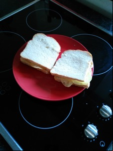Two sandwiches containing potato crisps