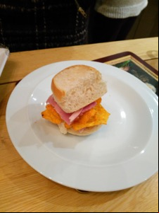 Dainty white roll containing ham and Doritos
