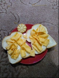 Corn snacks on buttered white bread with biscuit