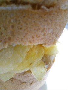 Close-up of potato crisps in sliced white bread