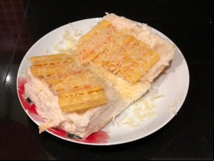 Frazzles and grated cheese on an open white roll