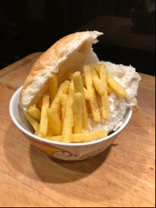 Half-open white roll with Chipsticks piled in
