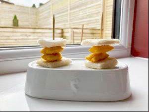Tiny Scampi Fries sandwiches on cocktail sticks