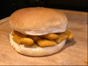 Buttered white roll containing Scampi Fries
