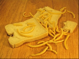 Torn white bread with scattered French Fries snacks