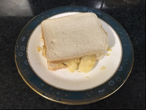 Potato crisps in white sliced bread