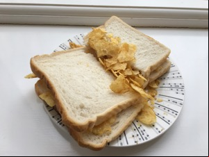 White crisp sandwich cut in half on a windowsill